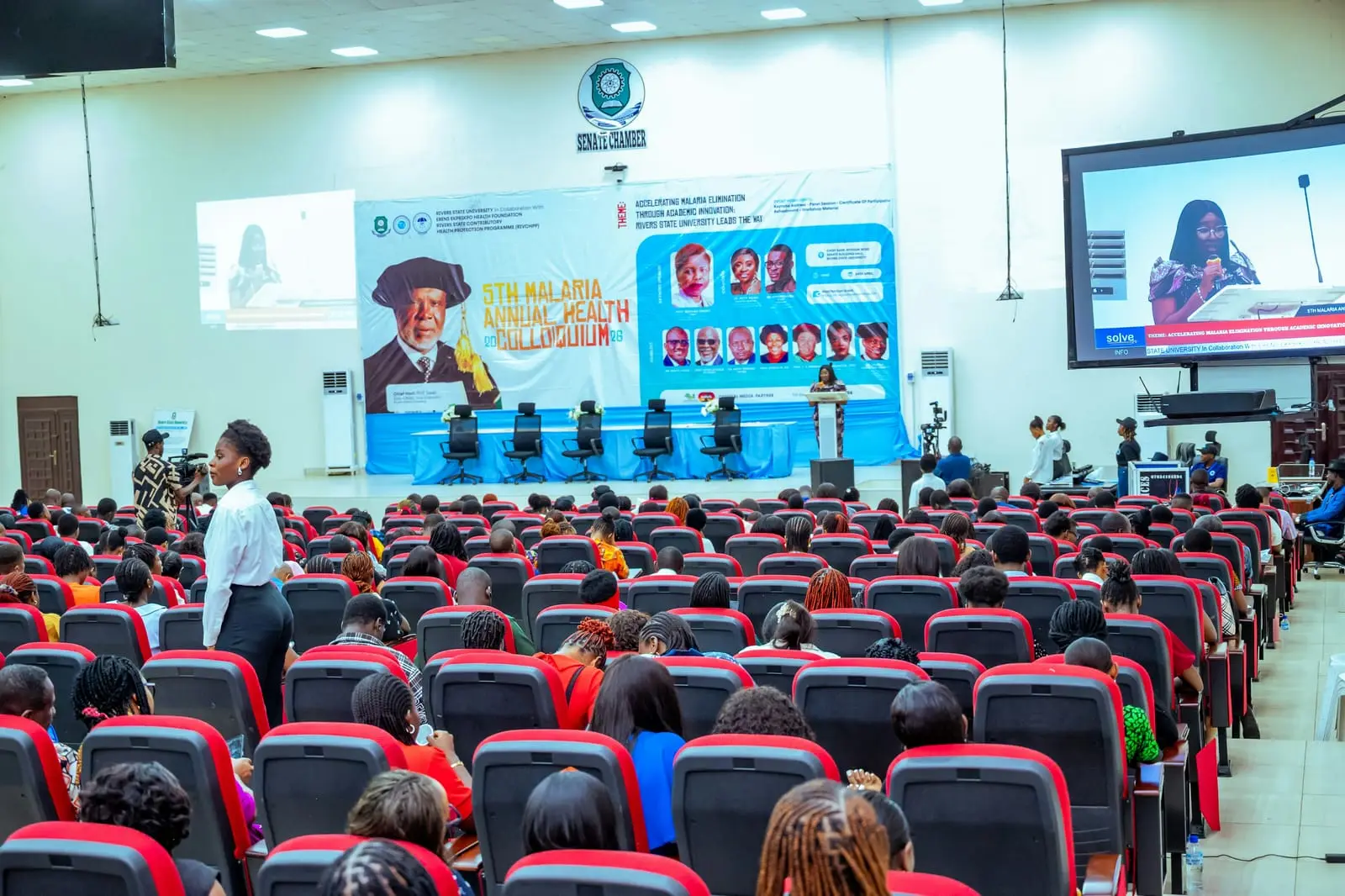A packed university auditorium during an academic event