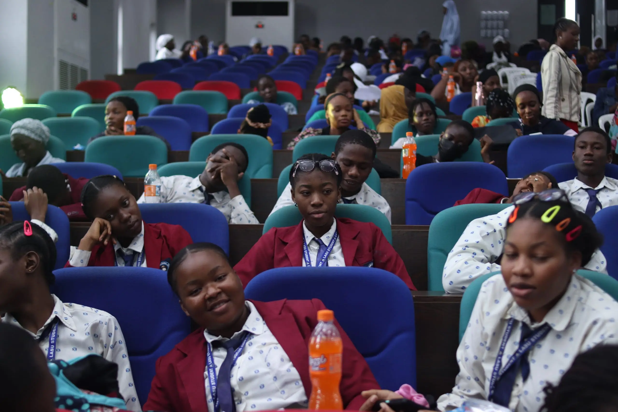 Young students seated together in a hall during a schools event